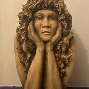 Dreams in Sycamore - carving of a young woman daydreaming